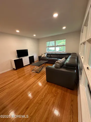 a large bedroom with a bed and window