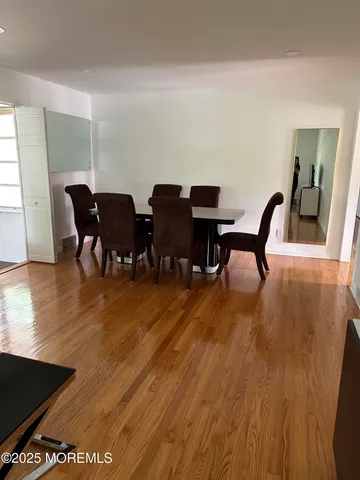 a kitchen with a table chairs a sink dishwasher window and cabinets