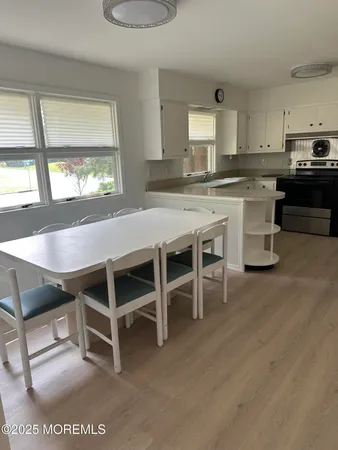 a room with wooden cabinets and stainless steel appliances