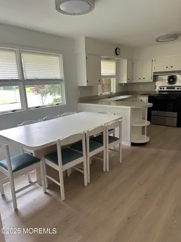 a room with wooden cabinets and stainless steel appliances