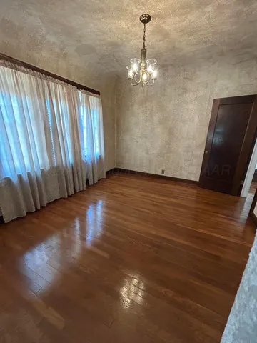 a view of a livingroom with hardwood floor and staircase
