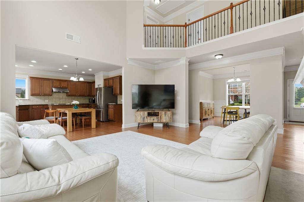 2572 Larson Creek Way Northwest Duluth, GA 30097 - Photo 18 of 50 a living room with furniture and a flat screen tv
