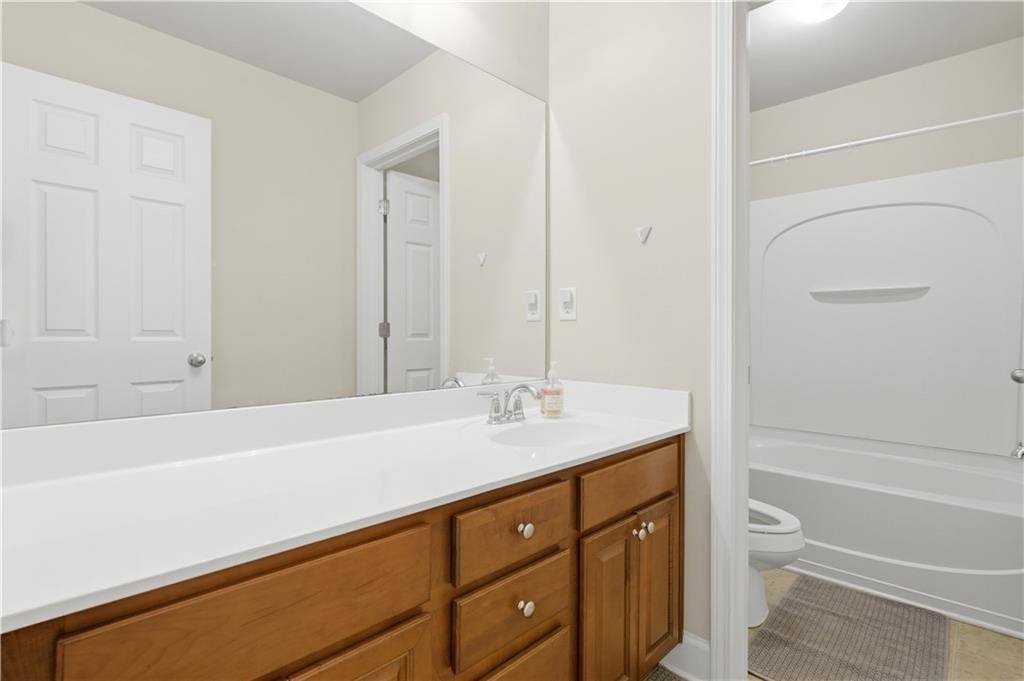 2572 Larson Creek Way Northwest Duluth, GA 30097 - Photo 29 of 50 a bathroom with a granite countertop sink toilet and shower
