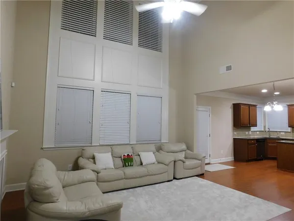 a living room with furniture and kitchen view