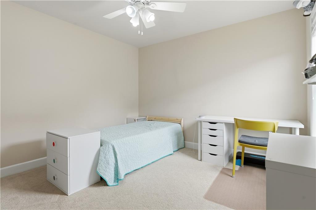 2572 Larson Creek Way Northwest Duluth, GA 30097 - Photo 32 of 50 a room with a bed and a chandelier