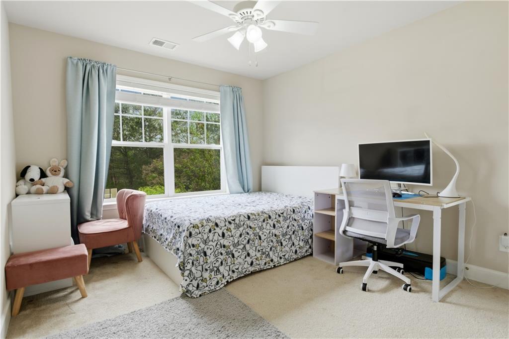2572 Larson Creek Way Northwest Duluth, GA 30097 - Photo 33 of 50 a bedroom with a bed and a flat screen tv