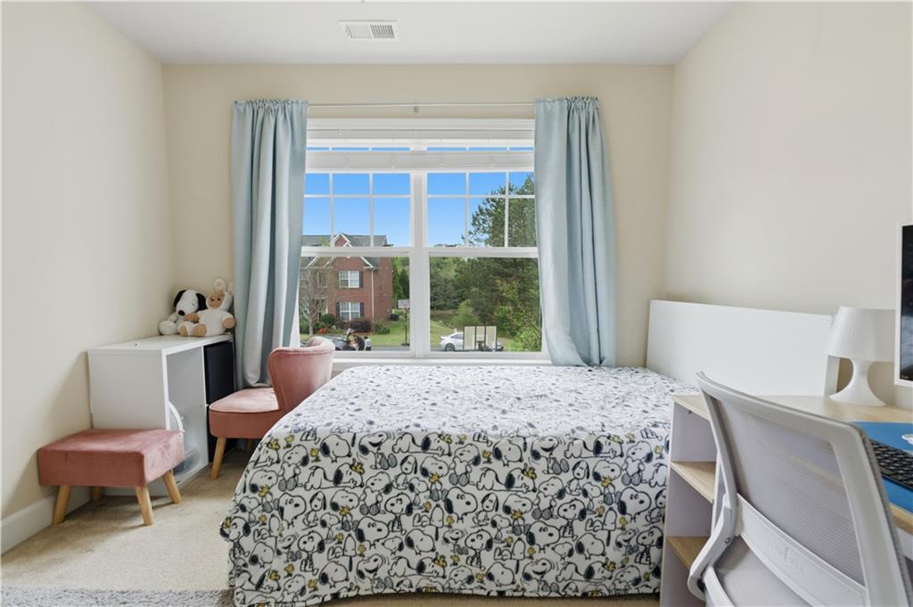 2572 Larson Creek Way Northwest Duluth, GA 30097 - Photo 34 of 50 a bedroom with a bed and glass window