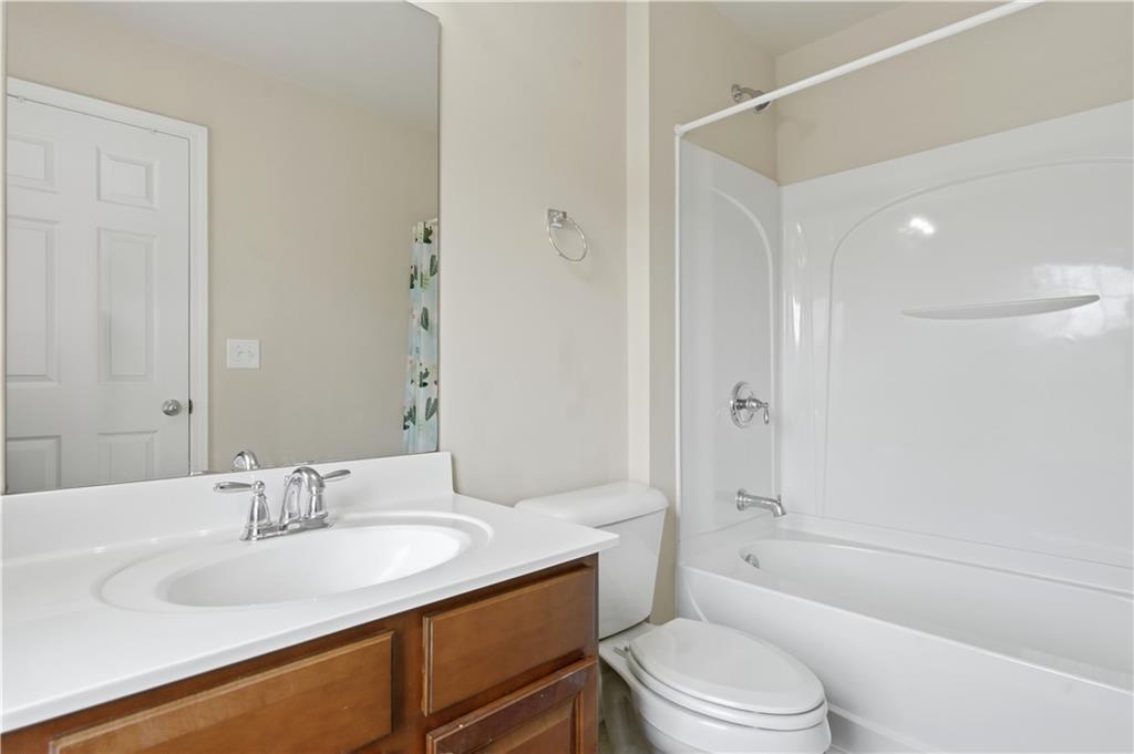 2572 Larson Creek Way Northwest Duluth, GA 30097 - Photo 37 of 50 a bathroom with a granite countertop sink toilet and shower