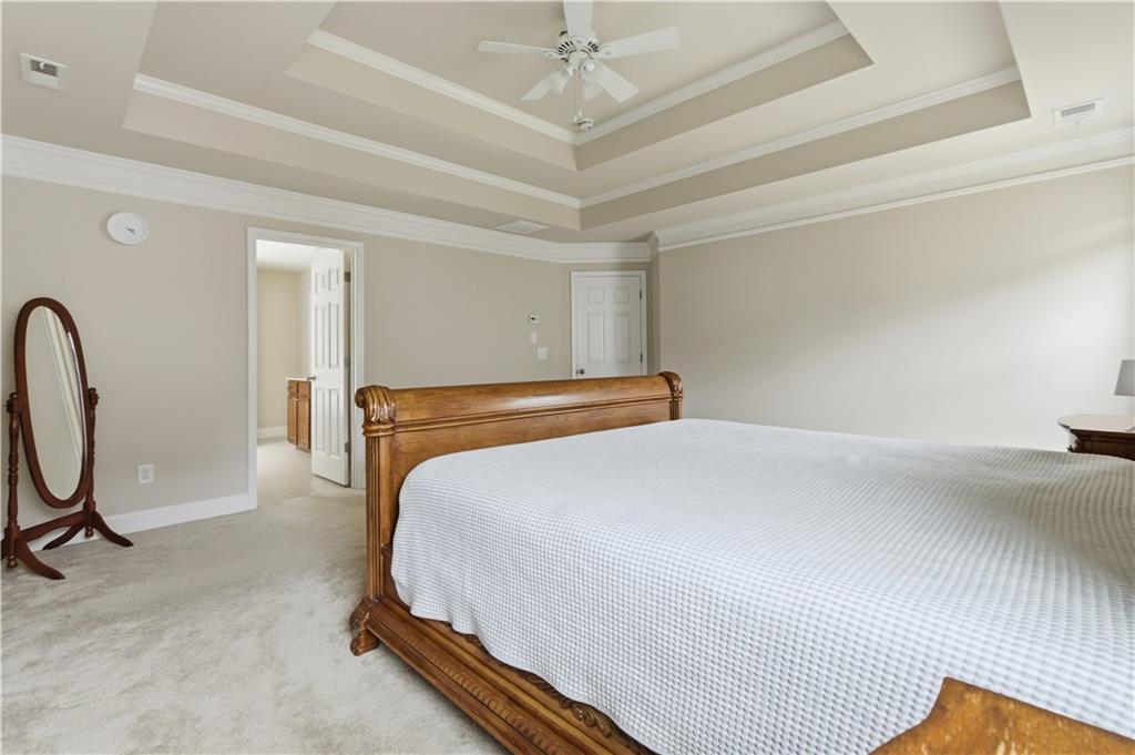 2572 Larson Creek Way Northwest Duluth, GA 30097 - Photo 42 of 50 a bedroom with a bed and a chandelier