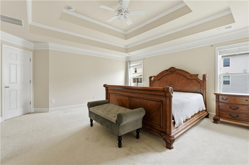 2572 Larson Creek Way Northwest Duluth, GA 30097 - Photo 43 of 50 a bedroom with a bed and a chandelier