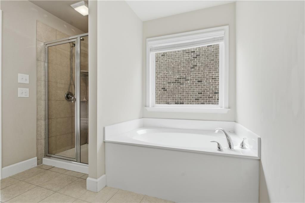 2572 Larson Creek Way Northwest Duluth, GA 30097 - Photo 45 of 50 a bathroom with a bathtub and shower