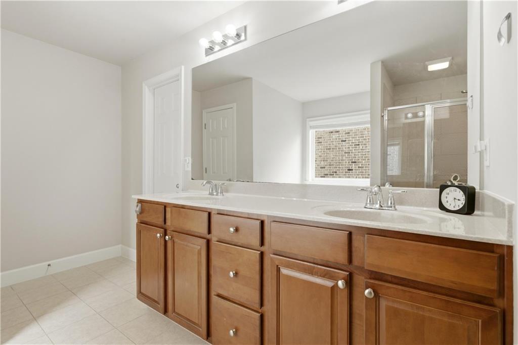 2572 Larson Creek Way Northwest Duluth, GA 30097 - Photo 46 of 50 a bathroom with a granite countertop sink and a mirror
