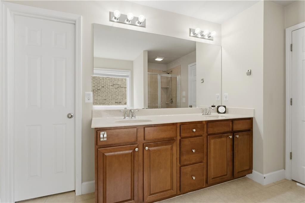 2572 Larson Creek Way Northwest Duluth, GA 30097 - Photo 47 of 50 a bathroom with a double vanity sink and mirror