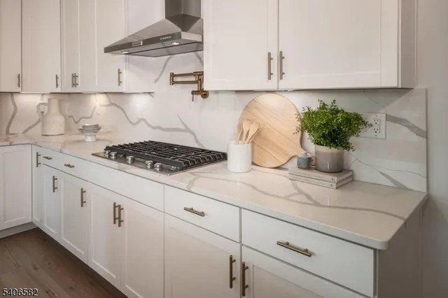 a kitchen with white cabinets and a stove