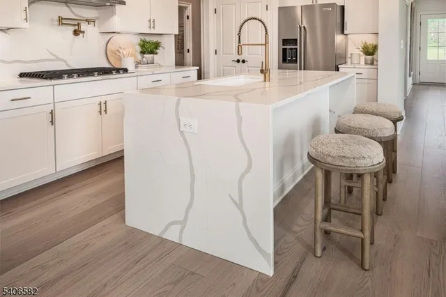 a kitchen with kitchen island a sink table and chairs