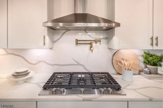 a view of swimming pool with lawn chairs and large trees