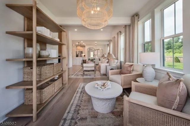 a living room with furniture a rug and a chandelier
