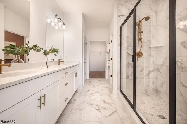 a spacious bathroom with a shower sink and mirror