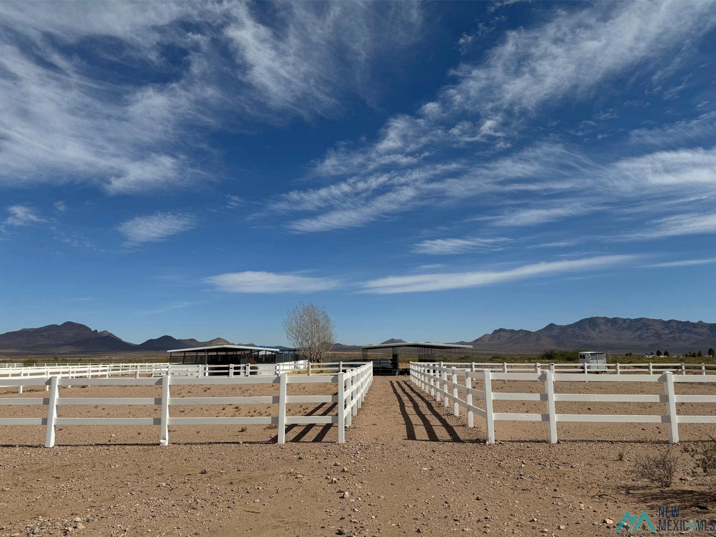 Tbd Tbd Caballos Road Rodeo, NM 88056 - Photo 6 of 46 View of yard featuring a mountain view, an enclosed horse arena, and an exterior structure