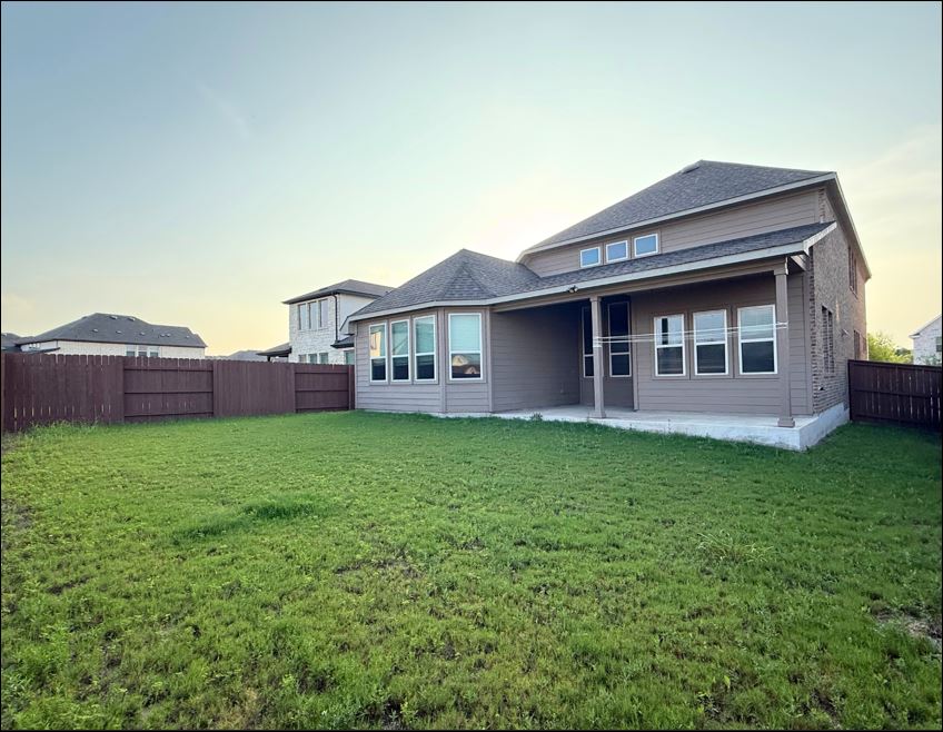 109 Rocky River Road Georgetown, TX 78628 - Photo 3 of 10 A spacious yard surrounds this two-story home, featuring a covered patio for outdoor enjoyment.