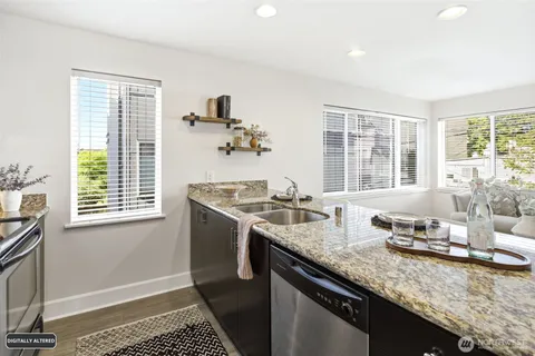 a kitchen with granite countertop lots of counter top space and living room