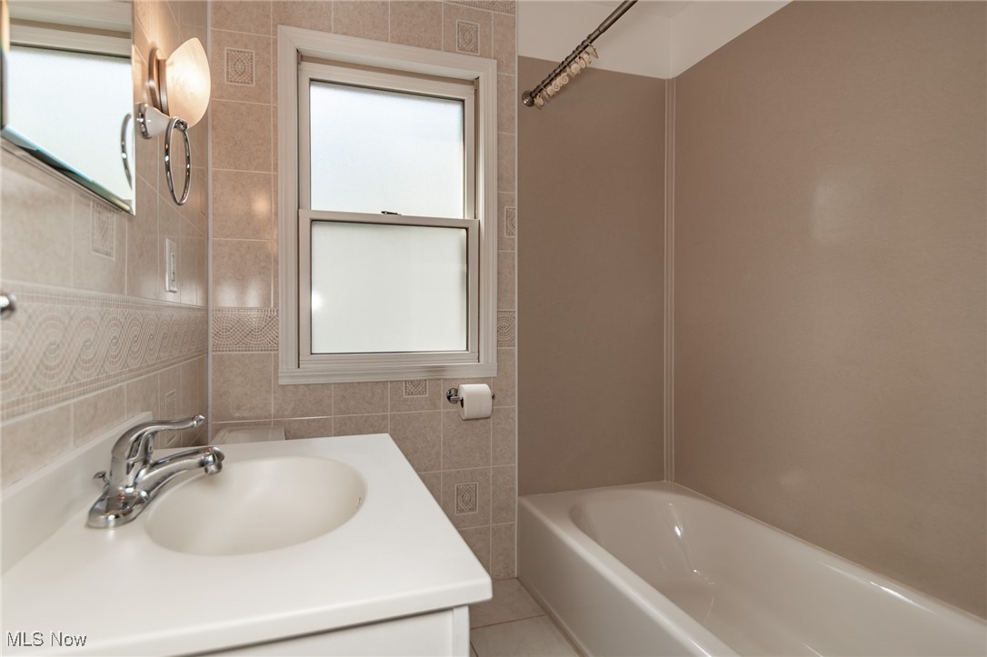 5223 Edenhurst Road Cleveland, OH 44124 - Photo 11 of 50 Full bathroom with tile walls, vanity, and tub / shower combination