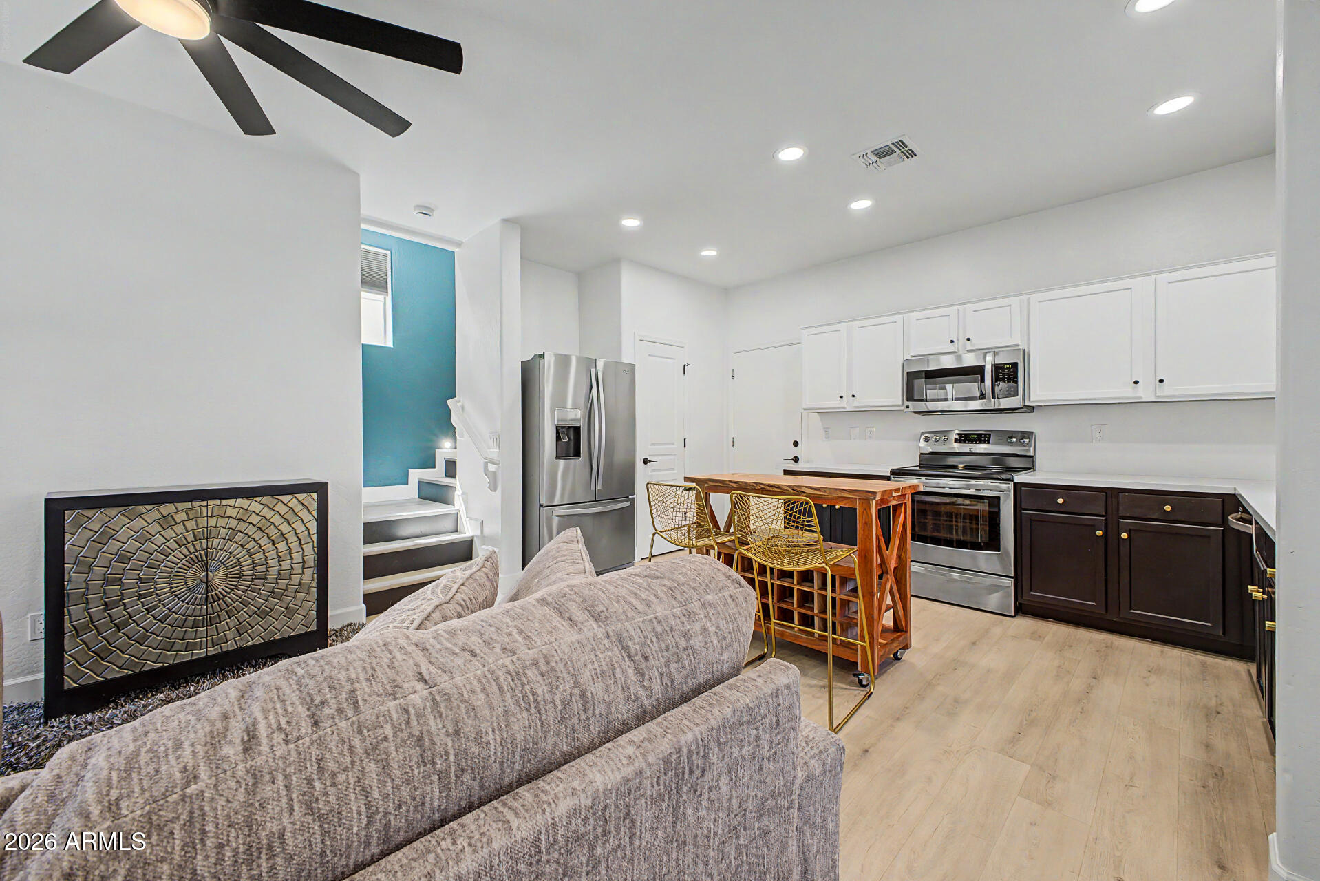 451 South Hawes Road, Unit 27 Mesa, AZ 85208 - Photo 3 of 27 a kitchen with stainless steel appliances kitchen island granite countertop a refrigerator and microwave