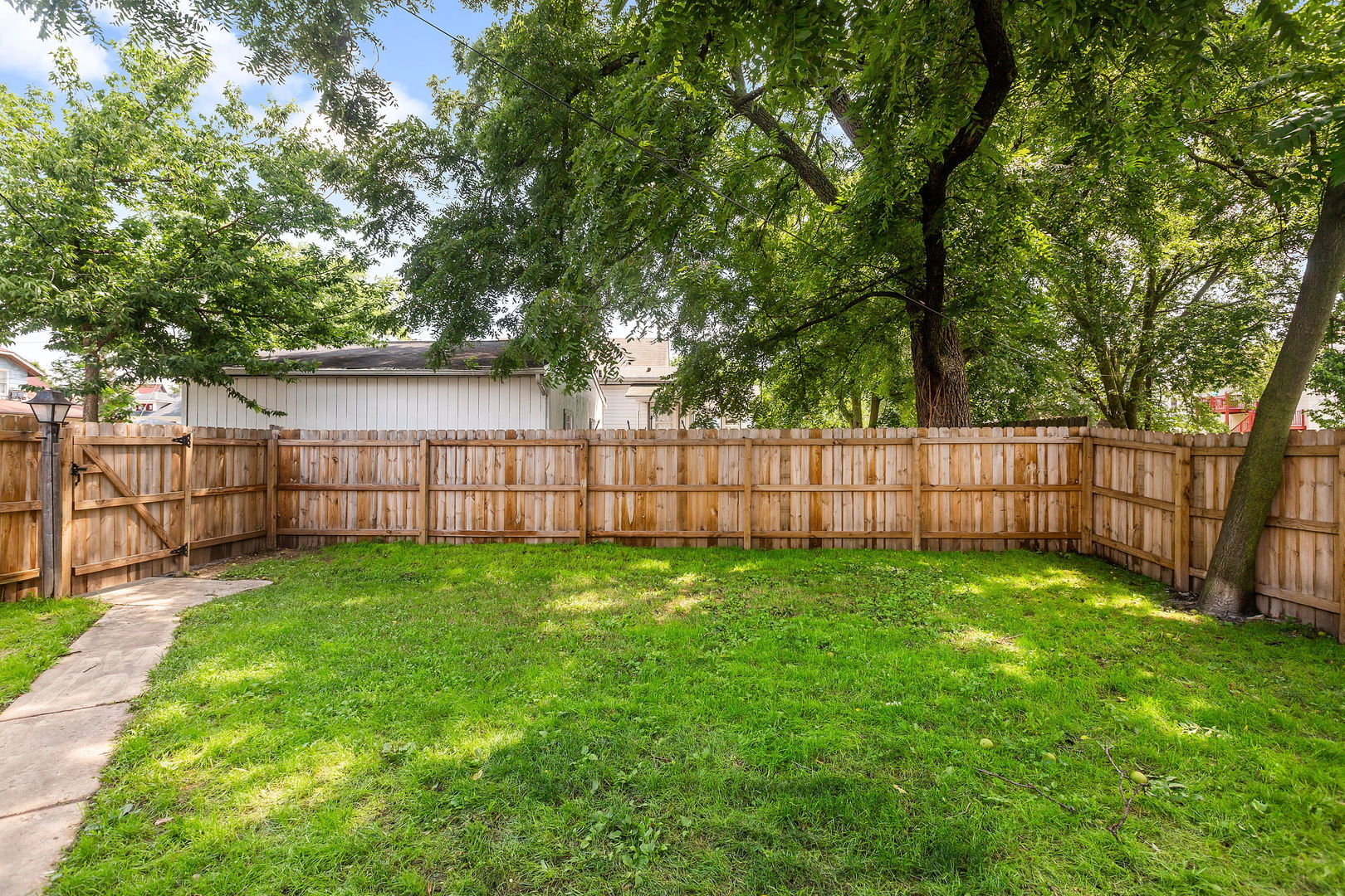 467 North Spring Street Elgin, IL 60120 - Photo 17 of 18 a view of a yard with wooden fence and a trees