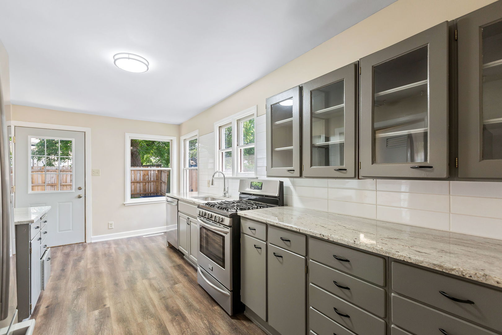 467 North Spring Street Elgin, IL 60120 - Photo 6 of 18 a kitchen with granite countertop stainless steel appliances a stove sink and cabinets