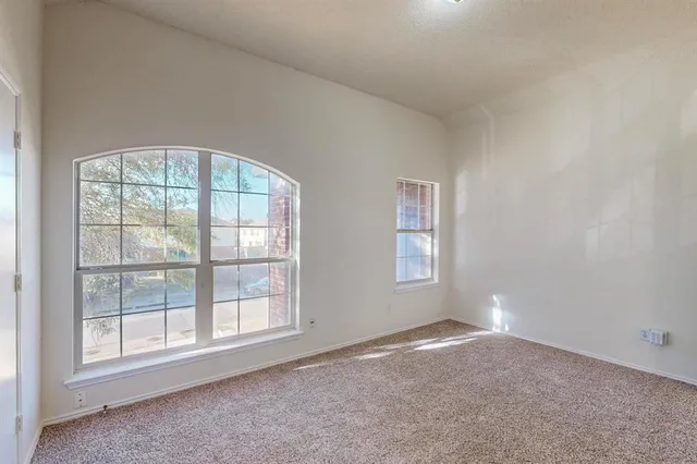 an empty room with a empty space and windows