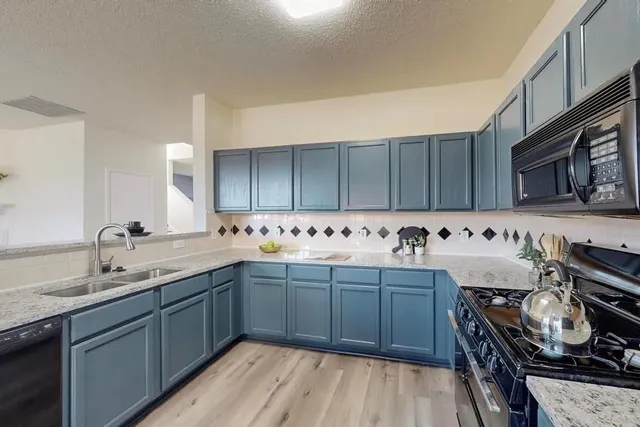 a kitchen with a sink and wooden cabinets