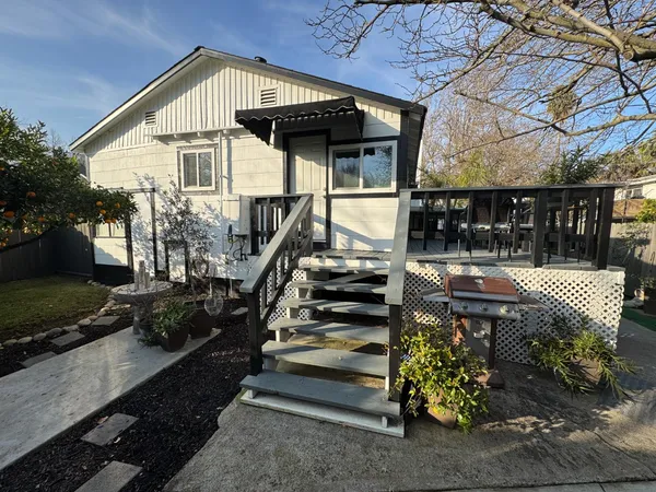 a view of a house with backyard and sitting area