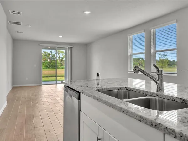 a kitchen with a sink and a large window