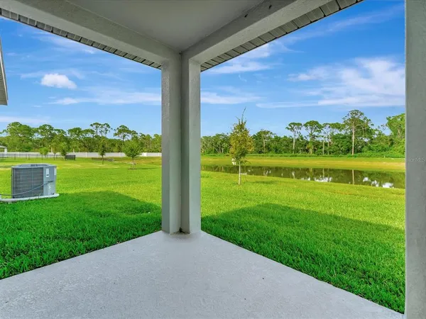 a view of a grassy field with an trees in the background
