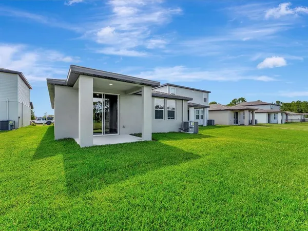 a view of an house with backyard space and garden
