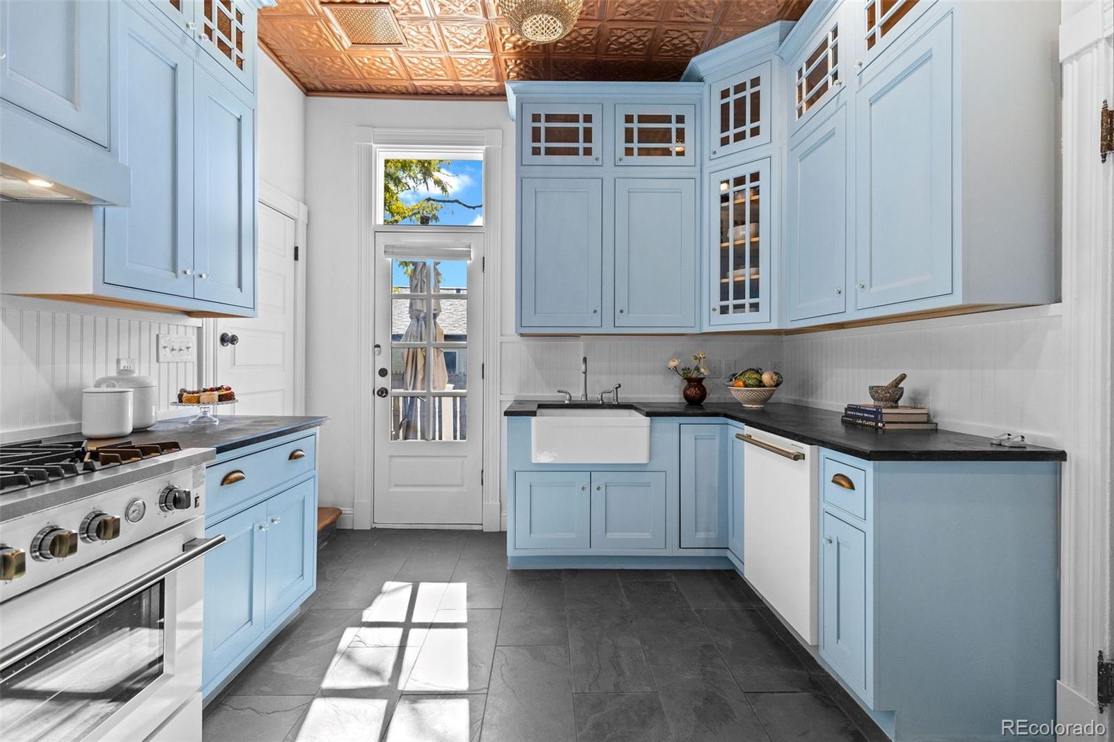 1389 Stuart Street Denver, CO 80204 - Photo 11 of 50 a kitchen with stainless steel appliances granite countertop a stove and cabinets