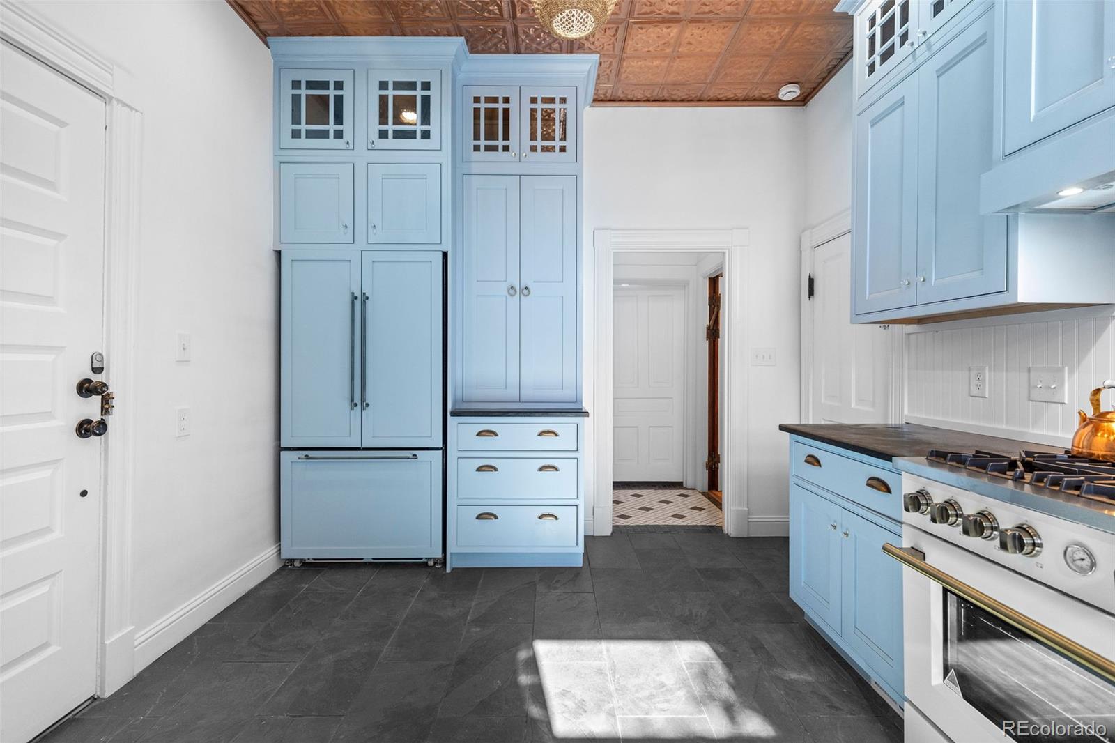 1389 Stuart Street Denver, CO 80204 - Photo 12 of 50 a kitchen with cabinets appliances and a window