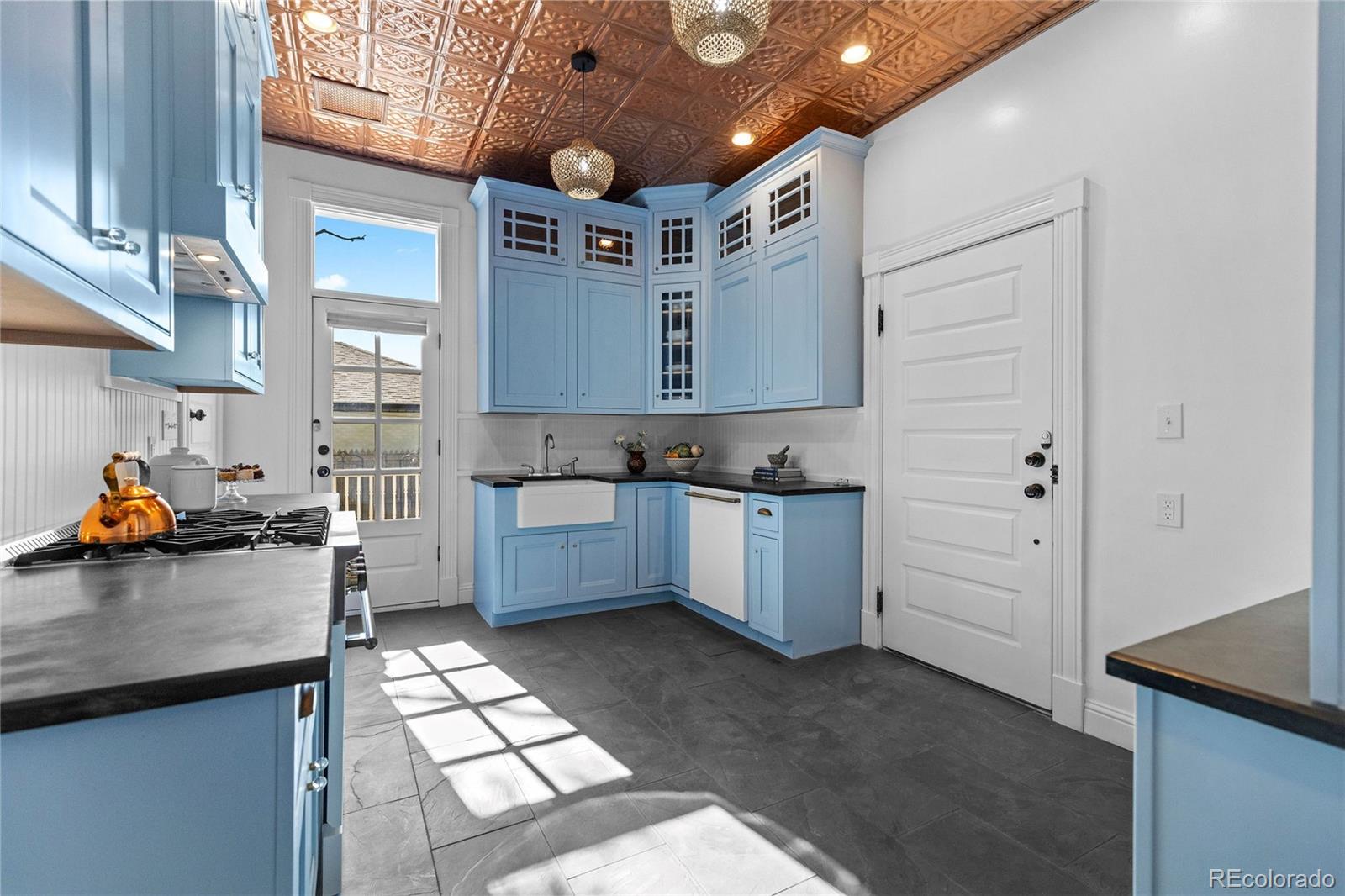 1389 Stuart Street Denver, CO 80204 - Photo 14 of 50 a kitchen with granite countertop a sink a counter space and cabinets