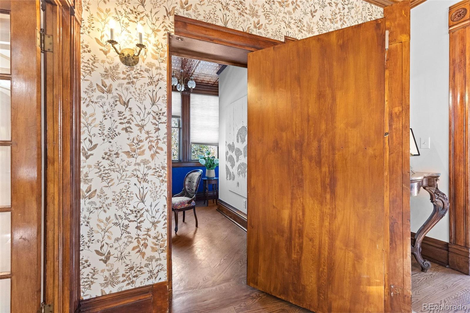 1389 Stuart Street Denver, CO 80204 - Photo 18 of 50 a view of a hallway with wooden floor and a bathroom