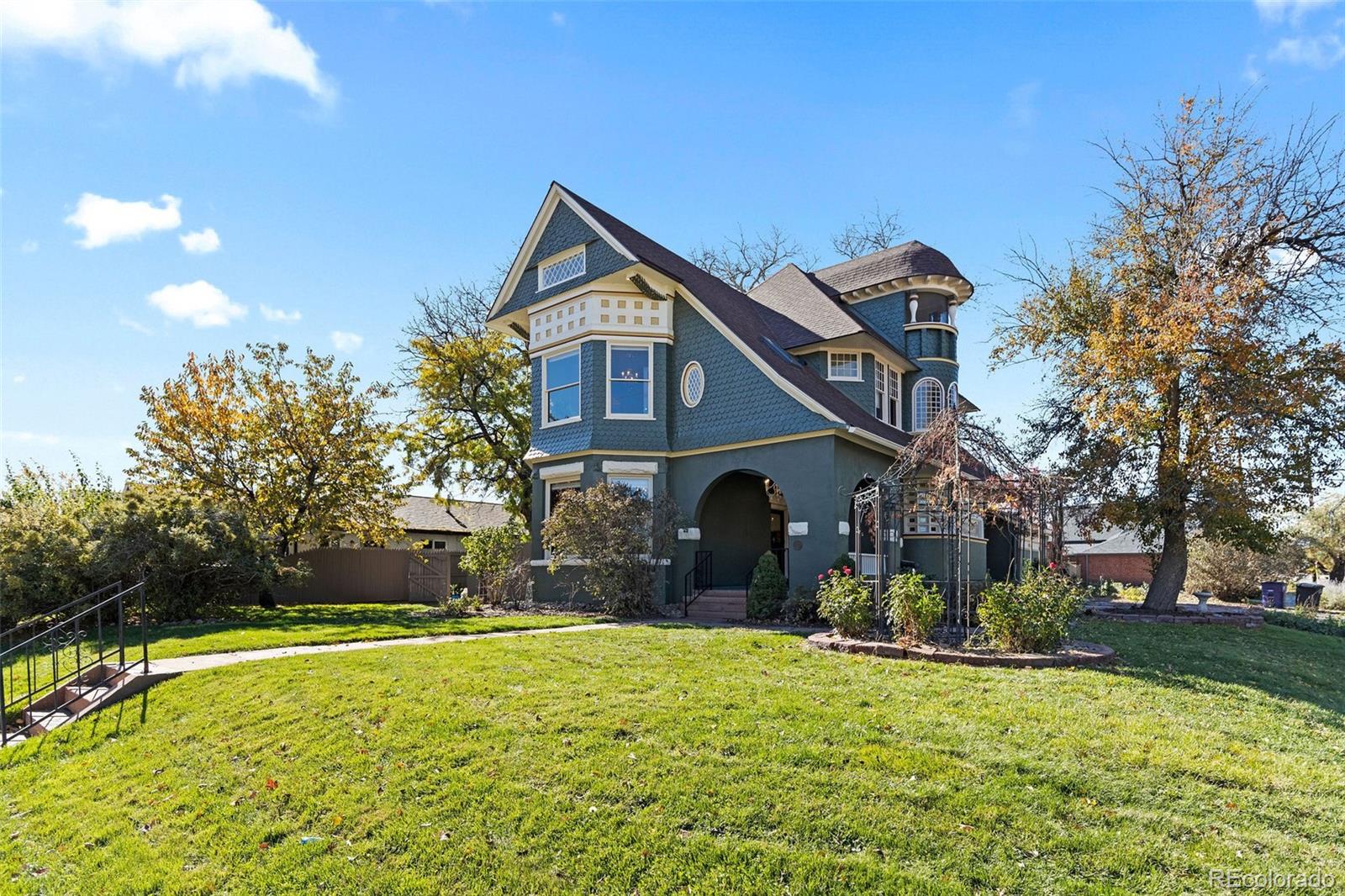 1389 Stuart Street Denver, CO 80204 - Photo 2 of 50 a front view of house with yard and trees in the background
