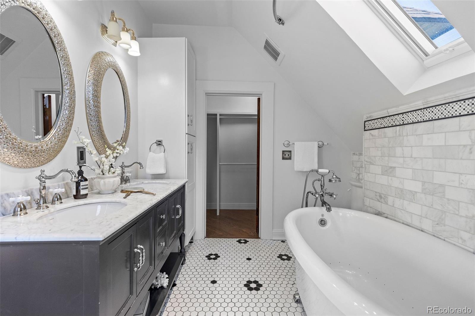 1389 Stuart Street Denver, CO 80204 - Photo 24 of 50 a bathroom with a double vanity sink mirror and bathtub