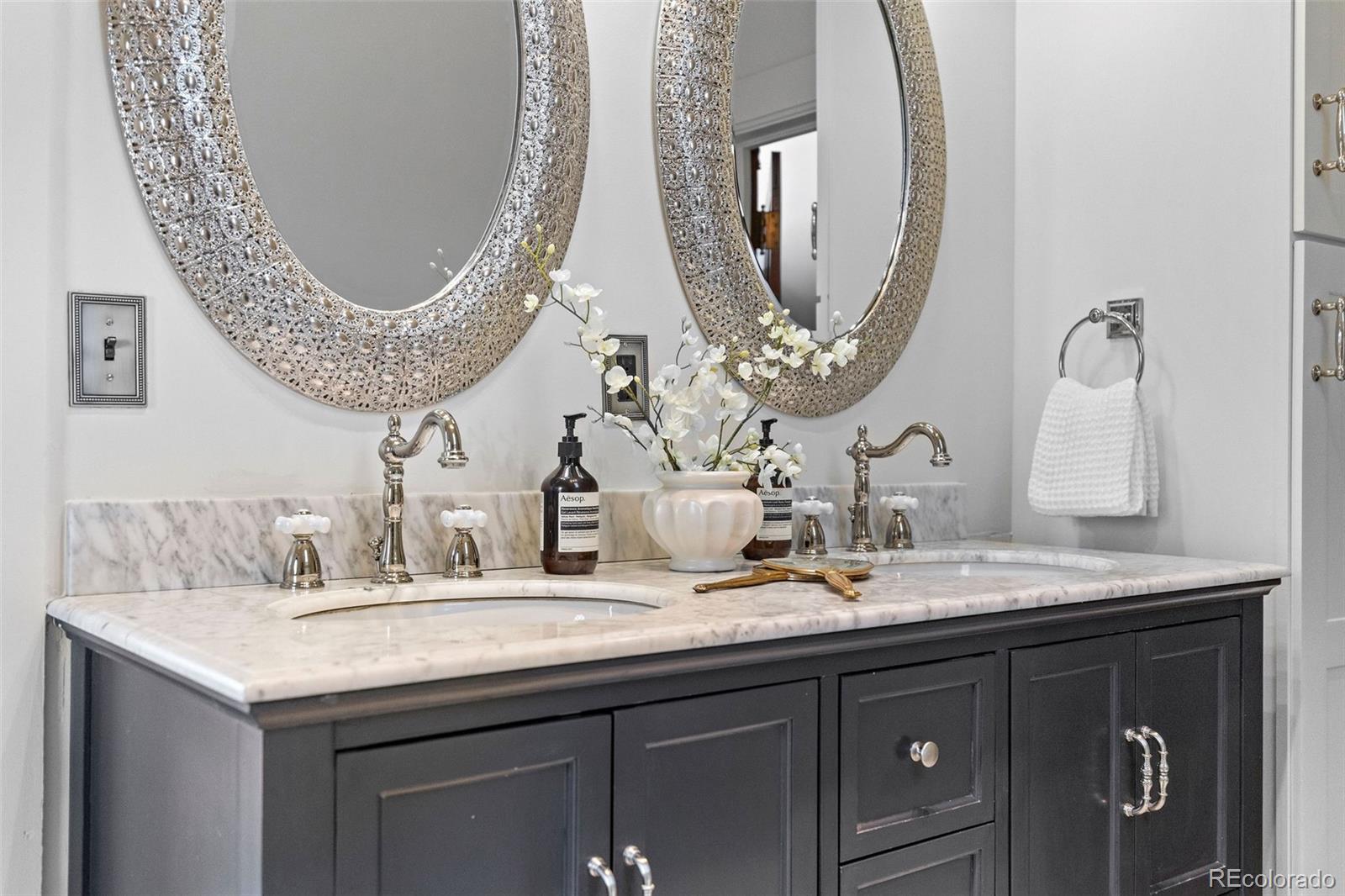 1389 Stuart Street Denver, CO 80204 - Photo 25 of 50 a bathroom with a mirror and a sink