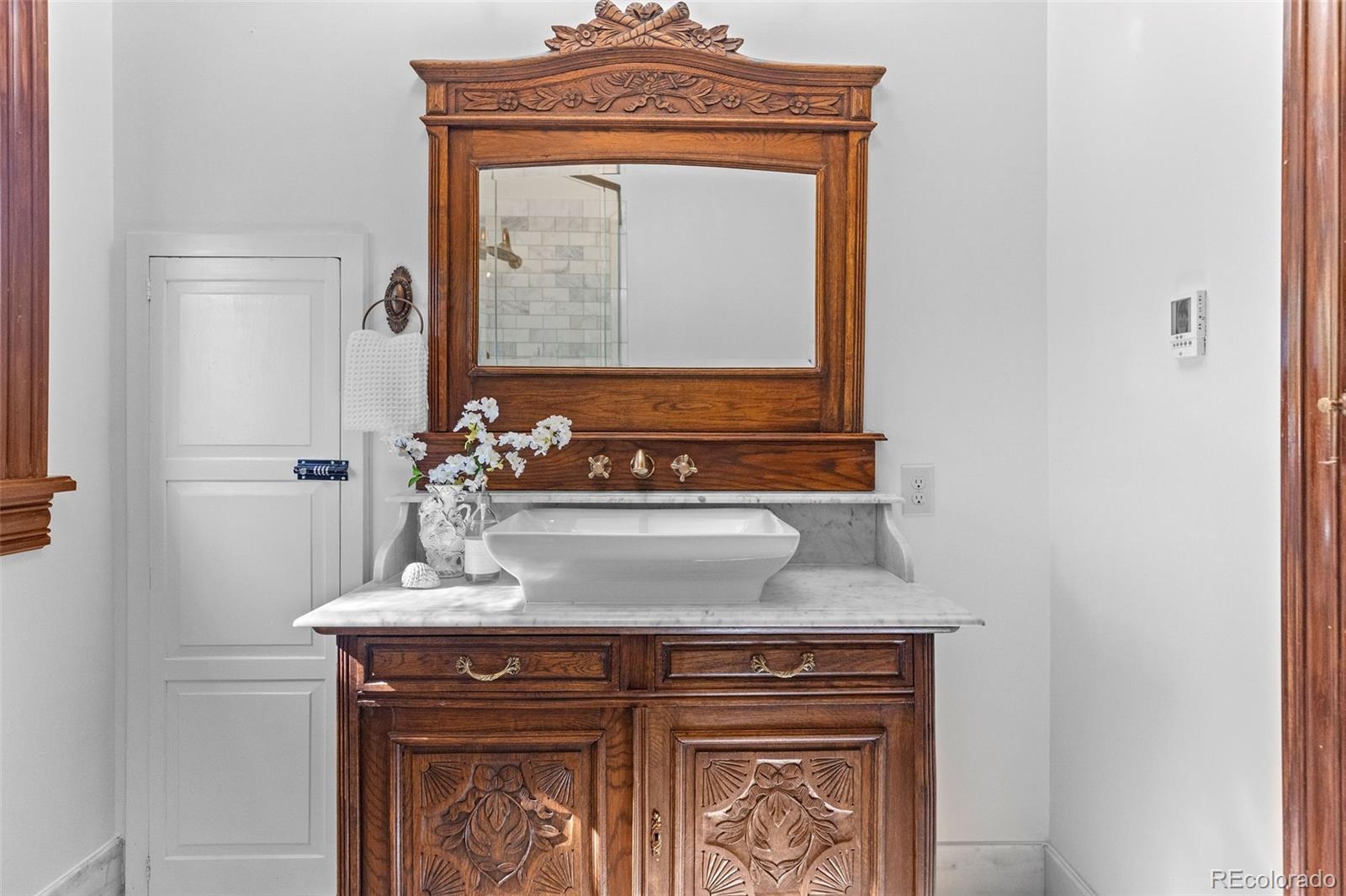 1389 Stuart Street Denver, CO 80204 - Photo 31 of 50 a view of bathroom with a sink and a mirror