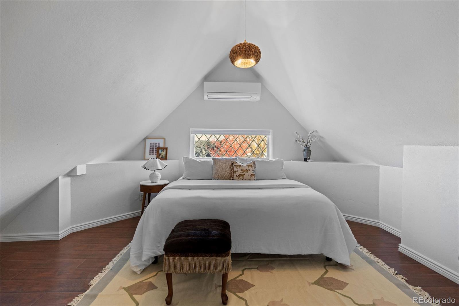 1389 Stuart Street Denver, CO 80204 - Photo 33 of 50 a bedroom with a bed and a lamp on table