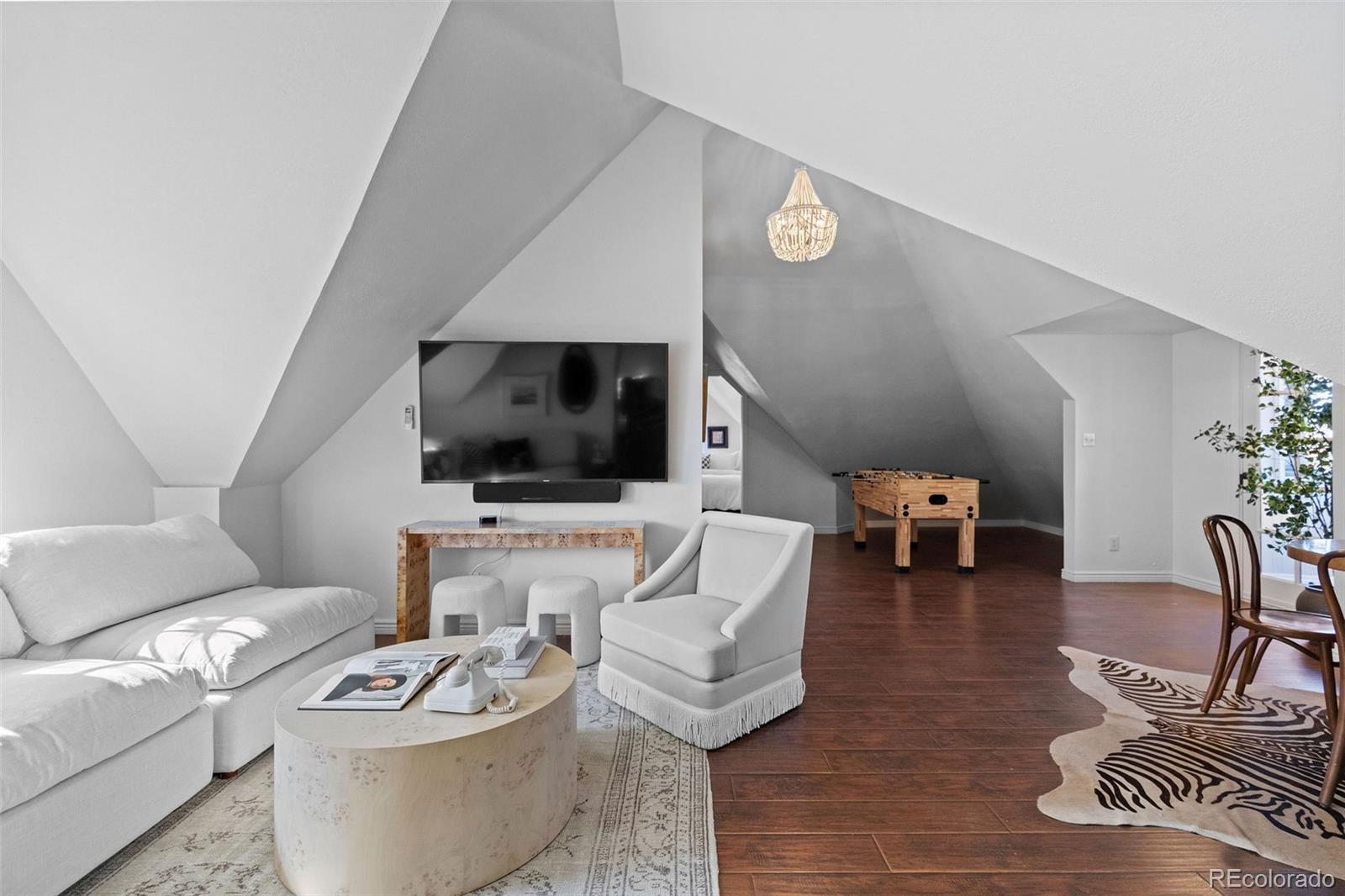 1389 Stuart Street Denver, CO 80204 - Photo 35 of 50 a living room with furniture and a flat screen tv