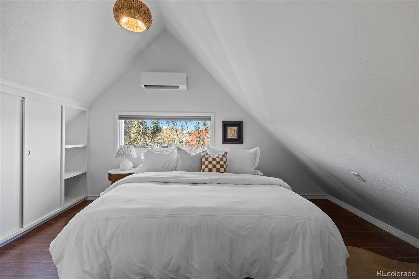 1389 Stuart Street Denver, CO 80204 - Photo 39 of 50 a large bed sitting in a bedroom next to a window