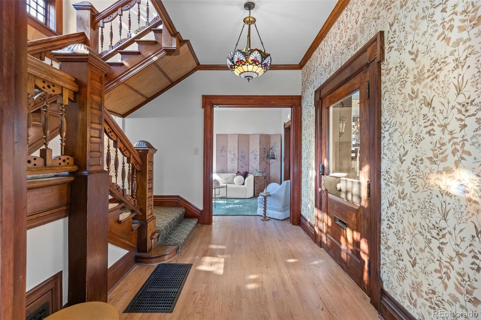 1389 Stuart Street Denver, CO 80204 - Photo 4 of 50 a view of a hallway with a livingroom with furniture