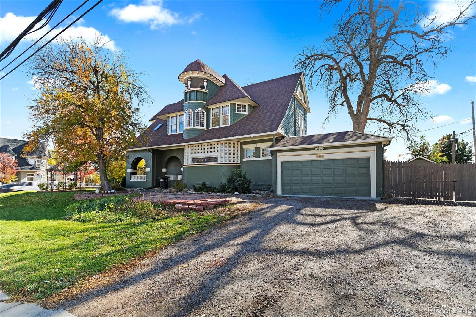 1389 Stuart Street Denver, CO 80204 - Photo 43 of 50 a front view of a house with a yard and garage