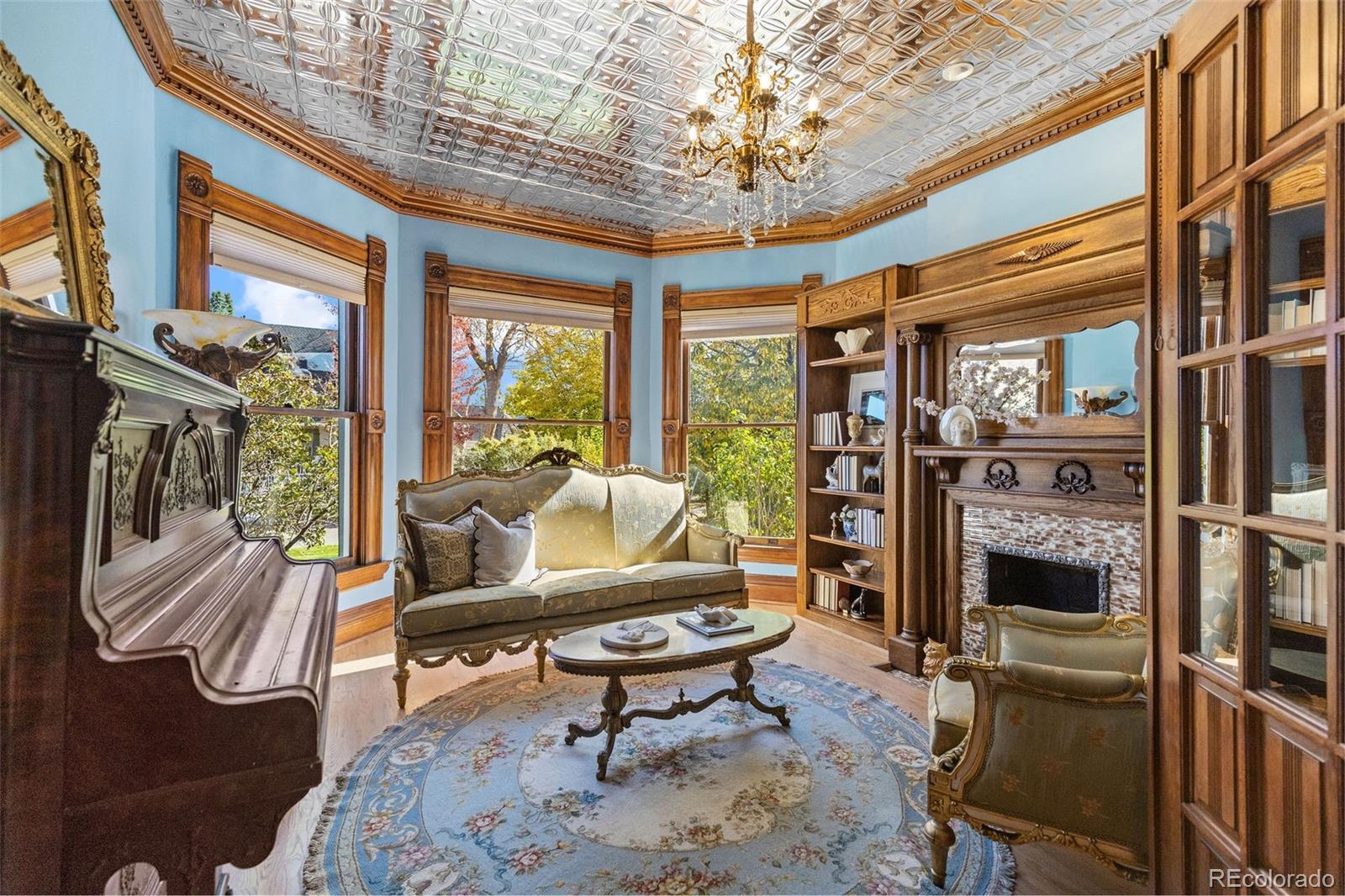 1389 Stuart Street Denver, CO 80204 - Photo 7 of 50 a living room with furniture a fireplace and a chandelier