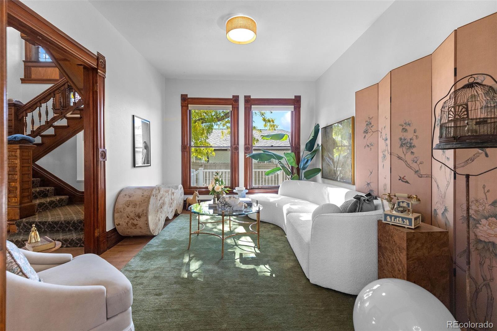 1389 Stuart Street Denver, CO 80204 - Photo 8 of 50 a living room with furniture a window and a chandelier